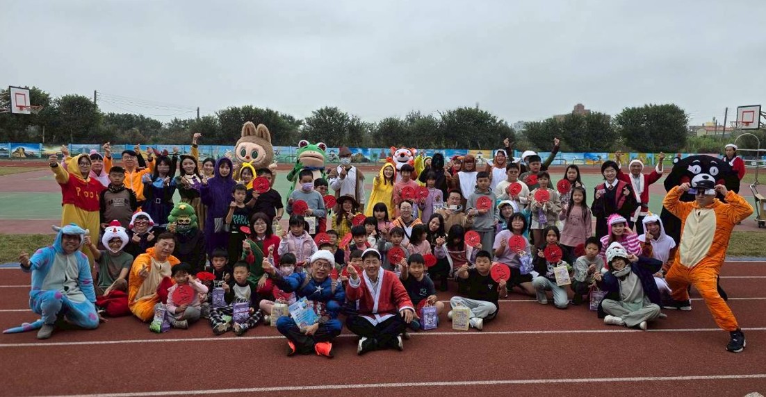 Yuhua students and teachers in costumes on the school running track for Halloween