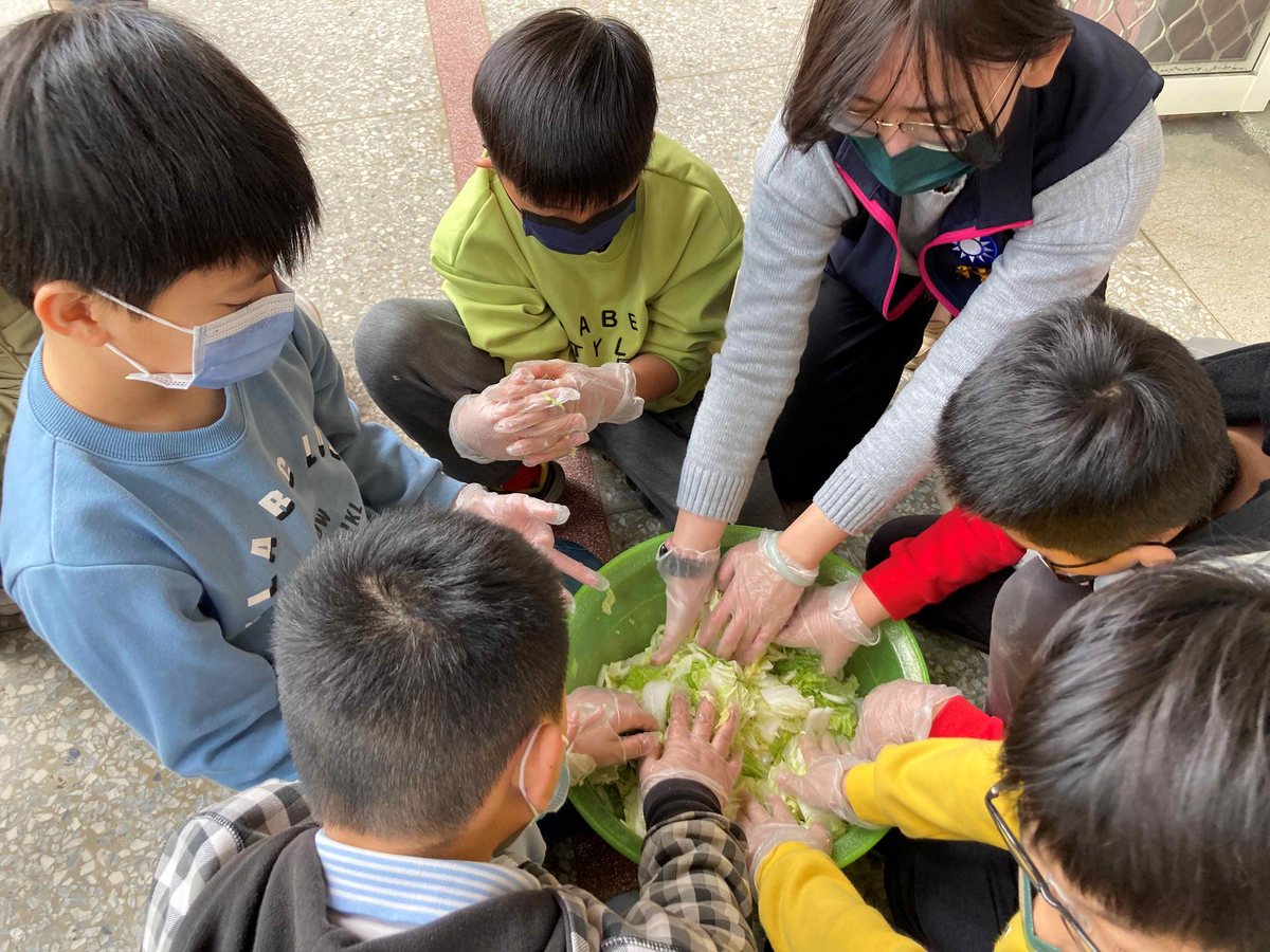 Students preparing fresh vegetables by hand